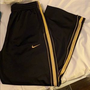 Nike black and gold loose track pants